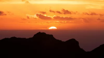 silhouette of mountain under sunset