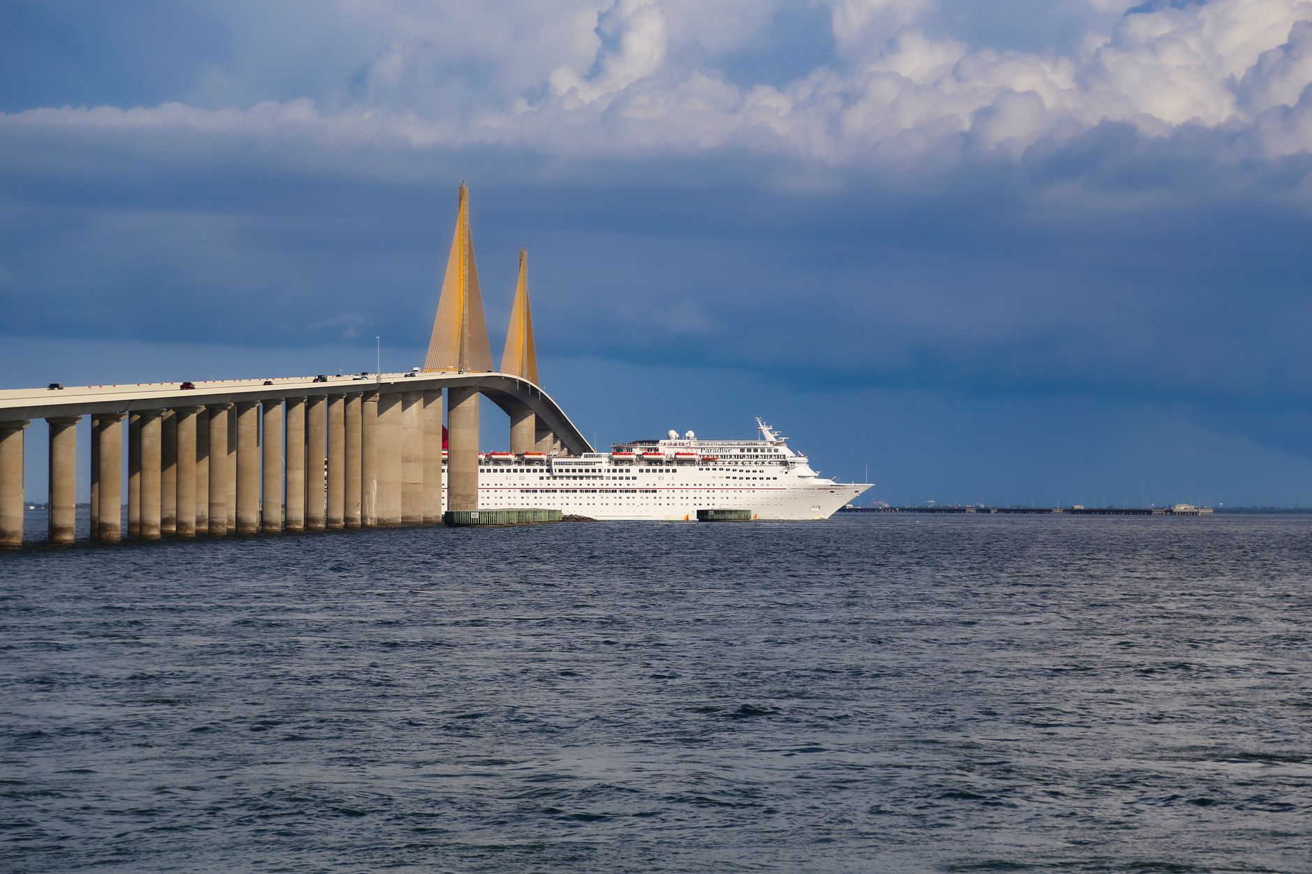 white cruise ship sailing on the sea under blue sky