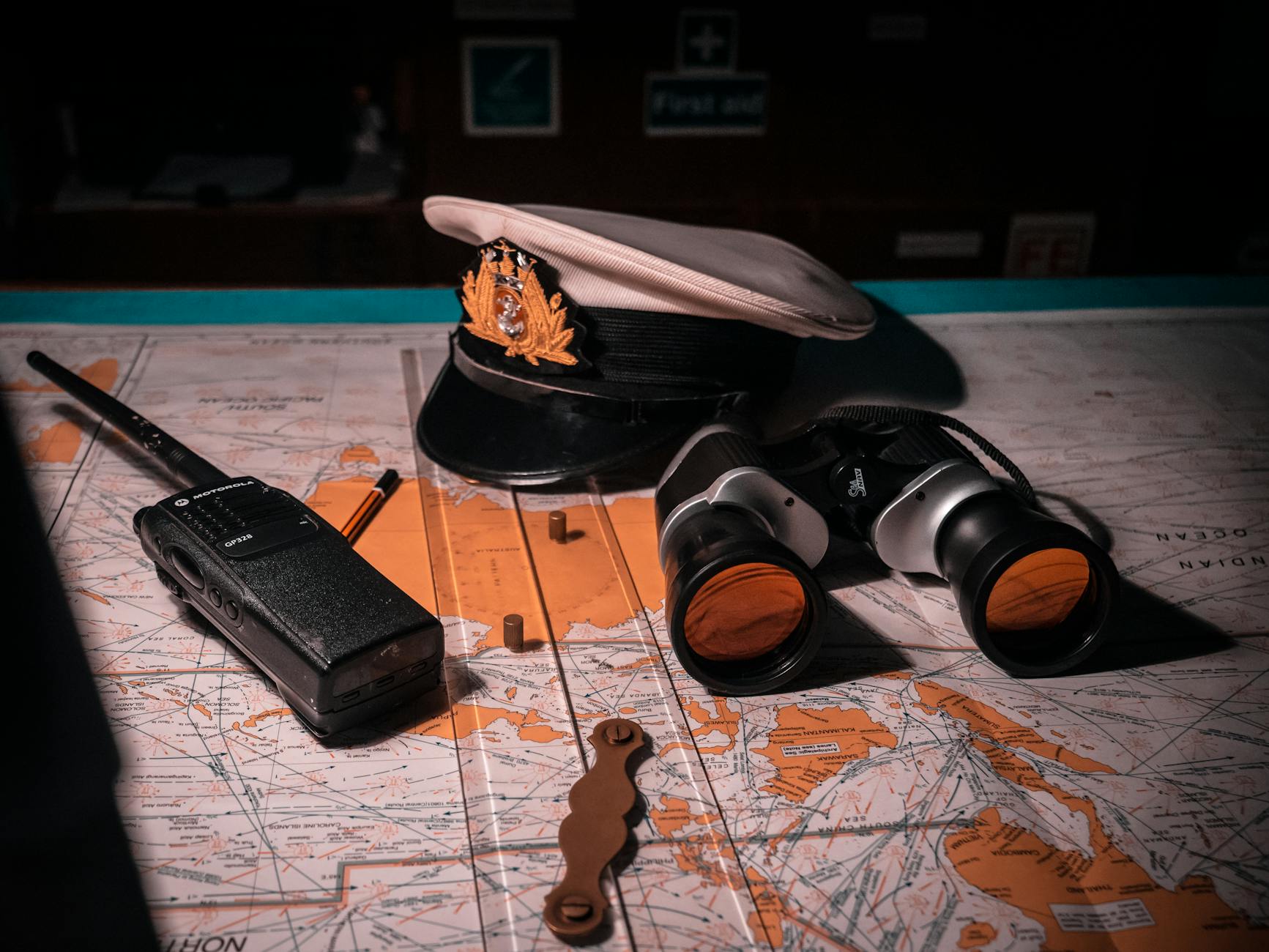 captains hat binoculars and walkie talkie left on the map