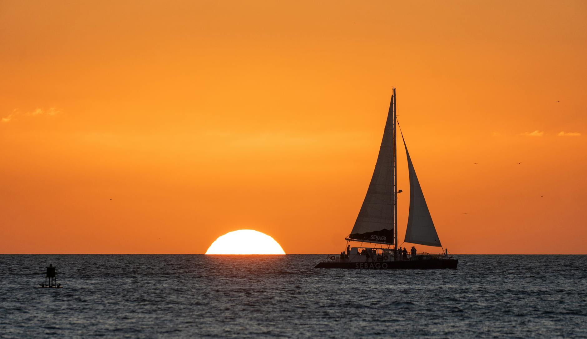 a sailboat on sea during sunset