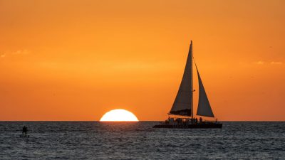 a sailboat on sea during sunset
