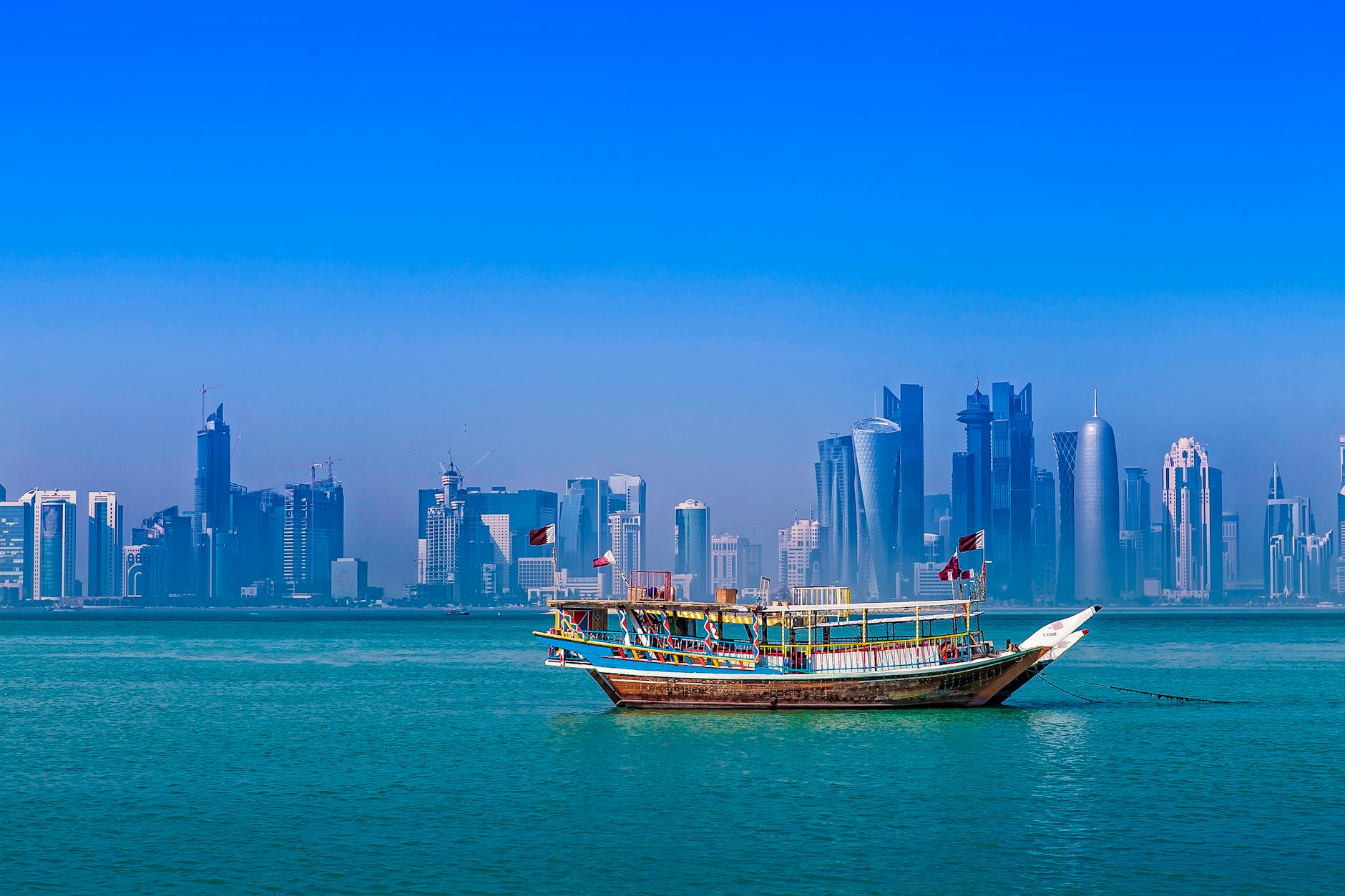 tourboat against downtown of doha