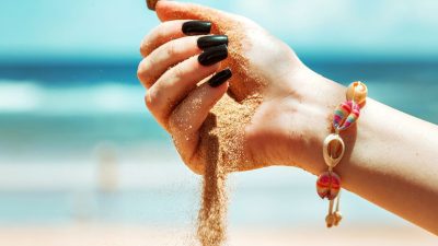 hand pouring sand