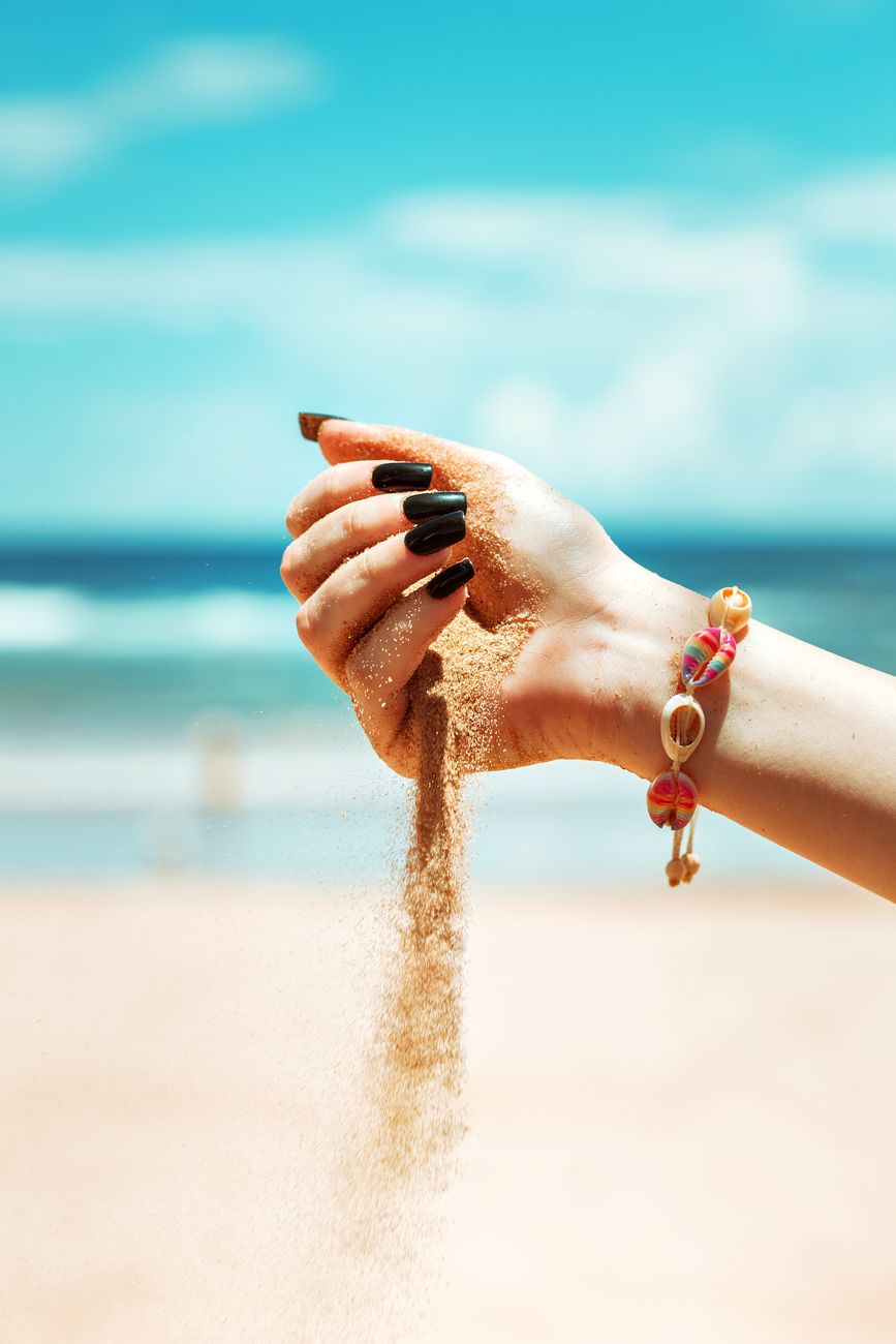 hand pouring sand