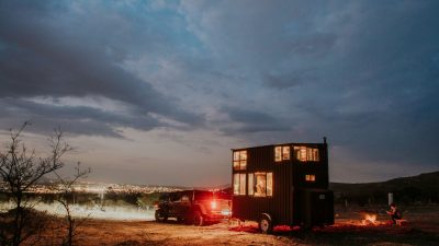 a car with a trailer at dusk