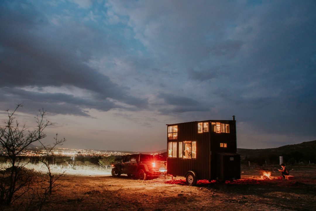 a car with a trailer at dusk
