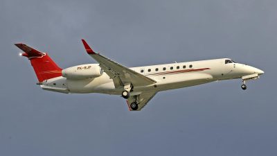 white and red charter plane flying under blue sky