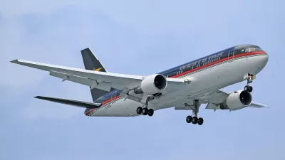 a blue and white airplane in the sky