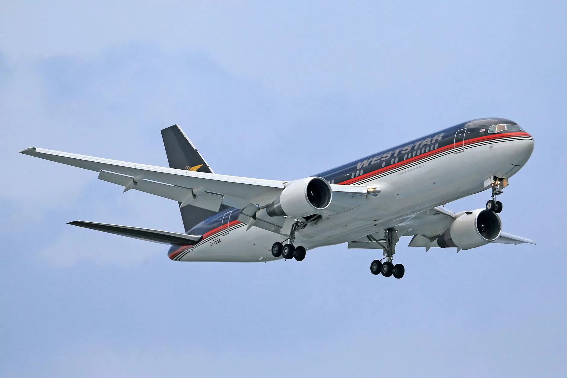 a blue and white airplane in the sky