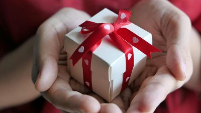 close up shot of a person holding a gift box