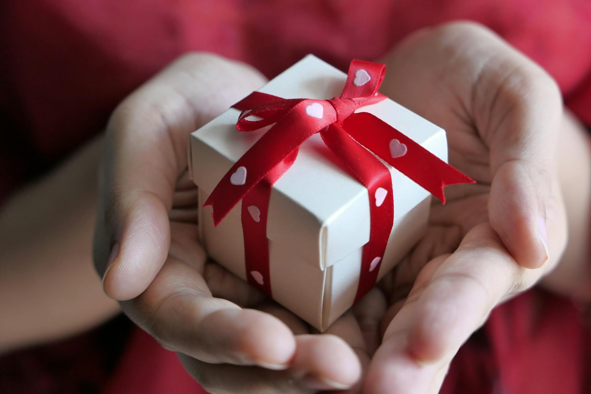 close up shot of a person holding a gift box