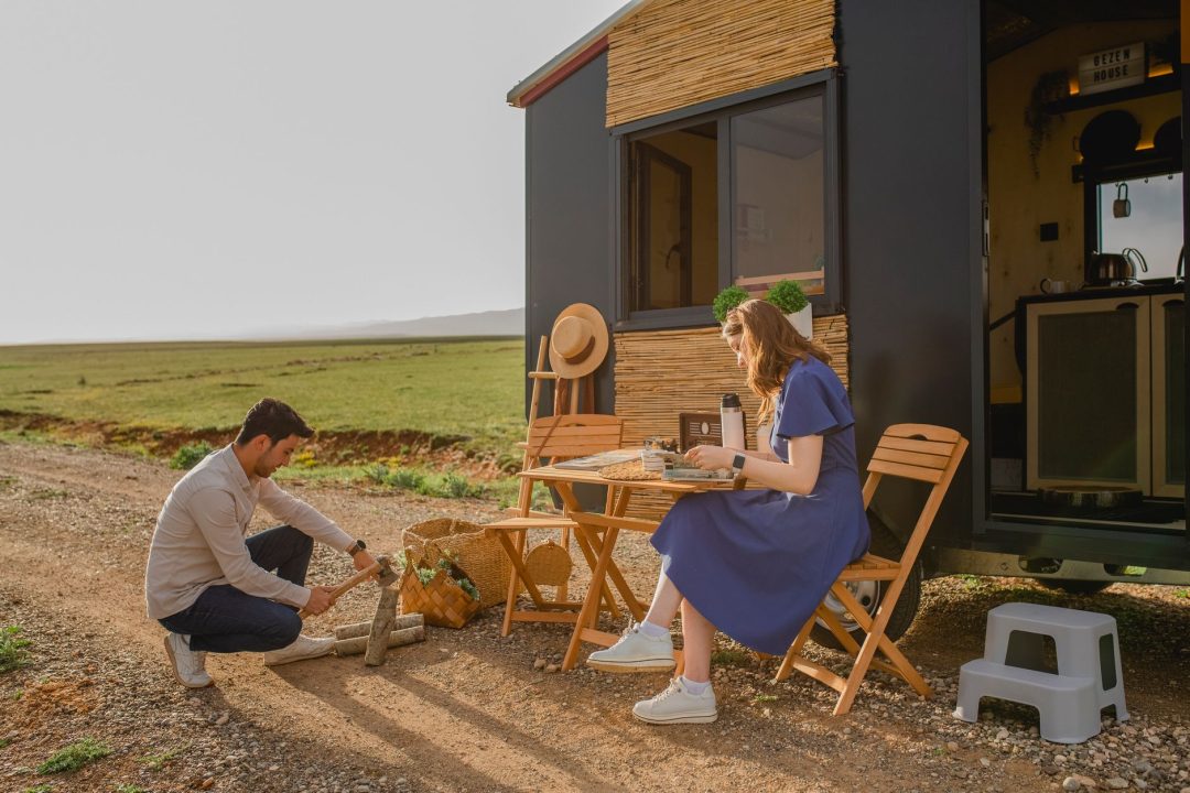 a couple in front of an rv