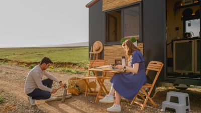 a couple in front of an rv