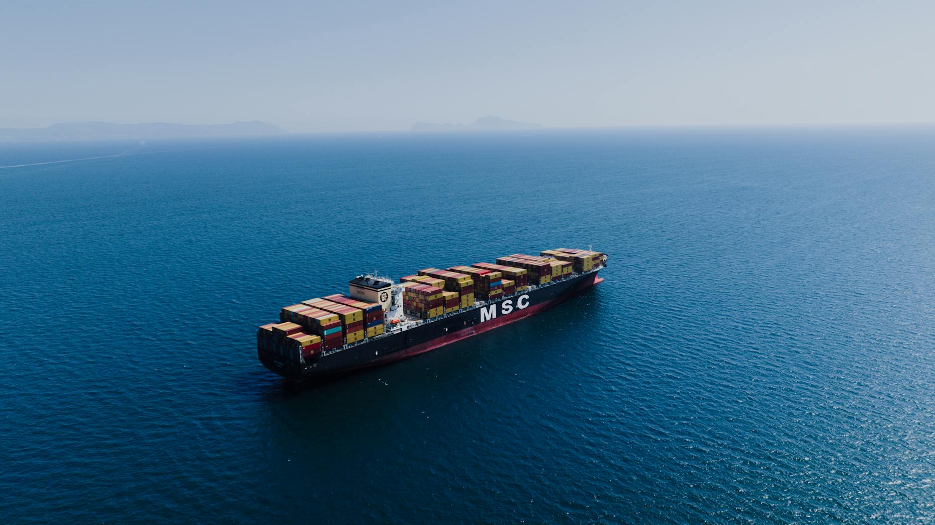 fully loaded cargo ship sailing on sea