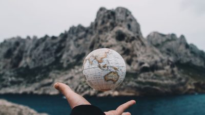 person tossing globe