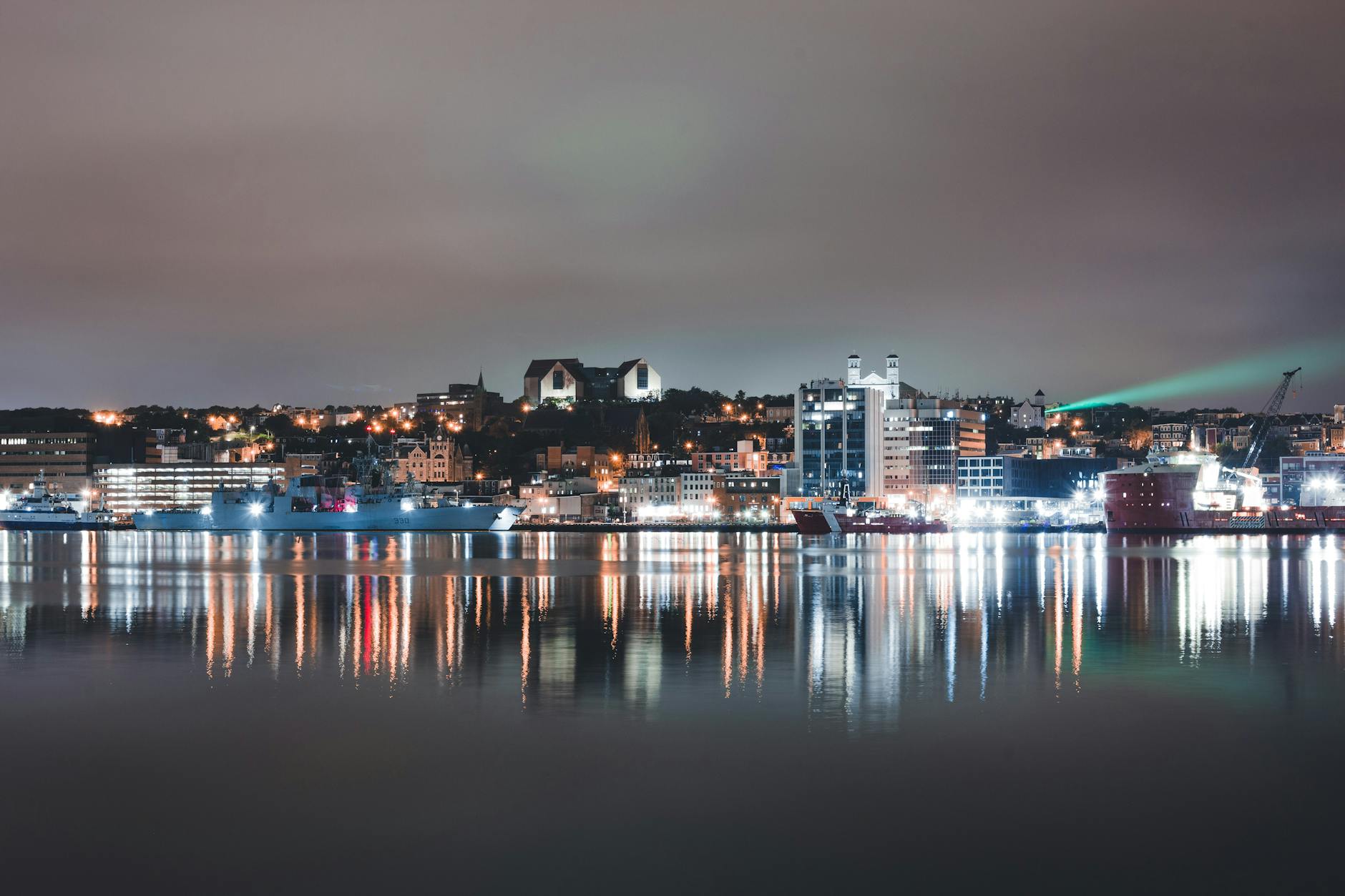 waterfront city buildings in lights reflection in water