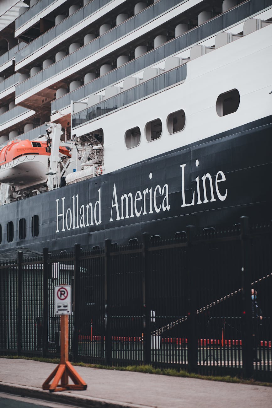 cruise ship docked at port with lifeboats visible