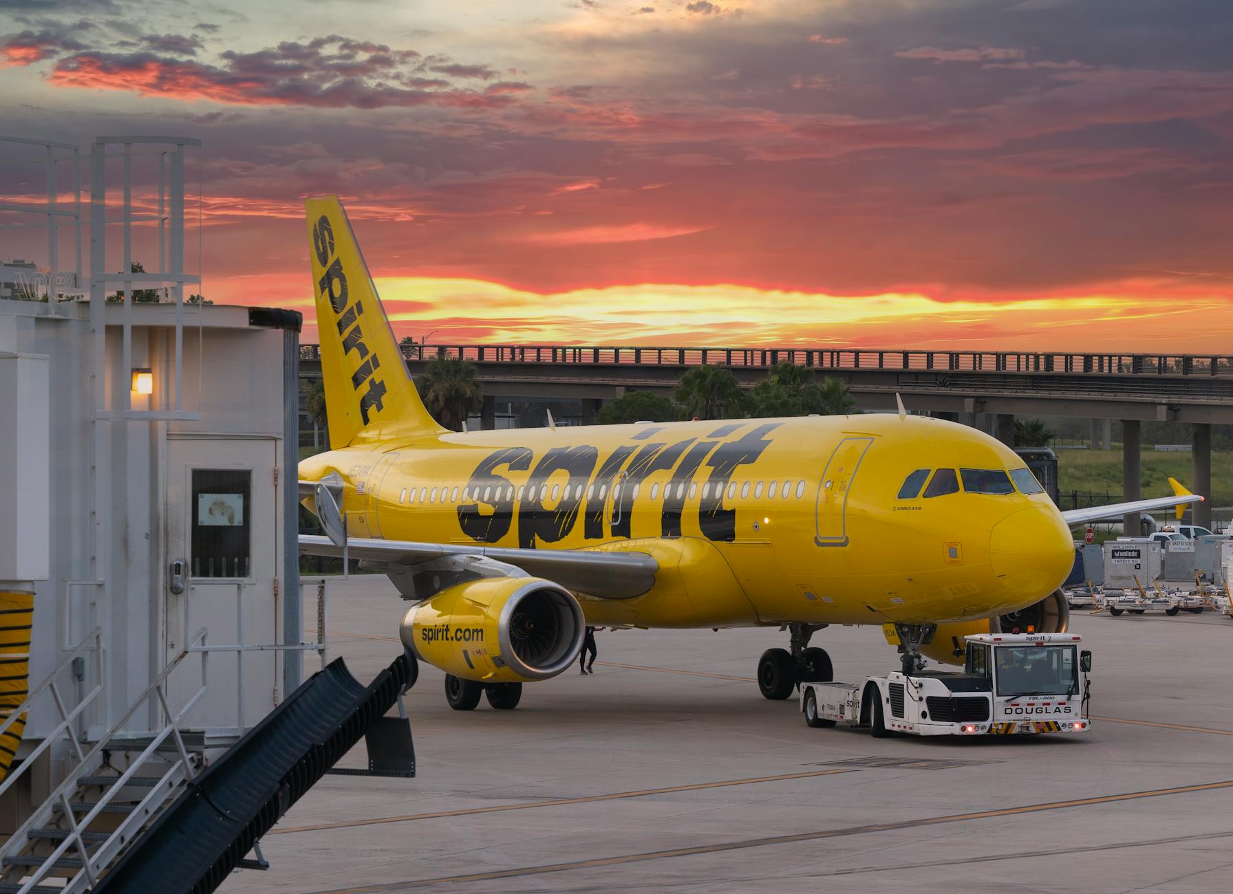 yellow passenger plane on the airport during sunset