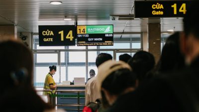back view of people queuing at an airport gate