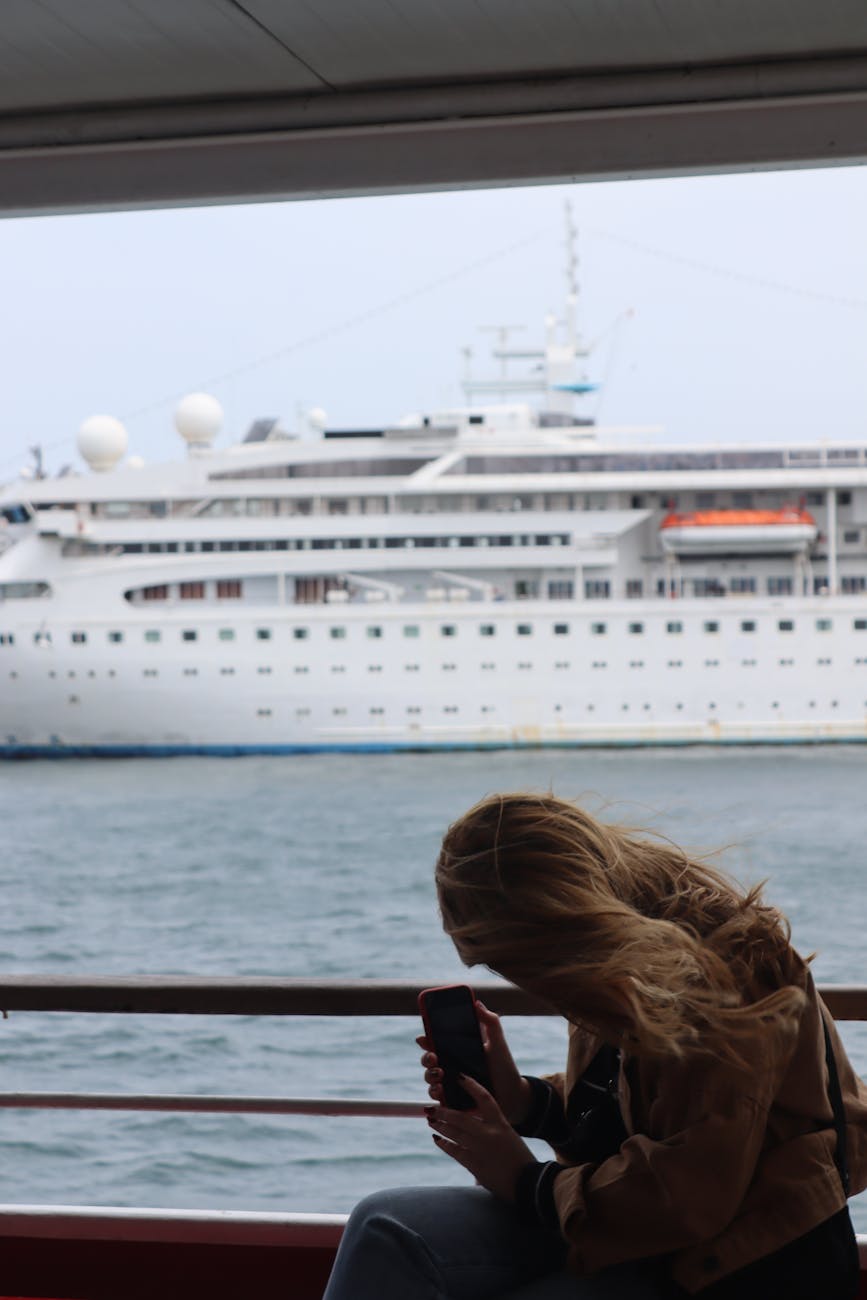 woman taking photo of a ferry ship