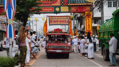 cars driving street during city festival in thailand