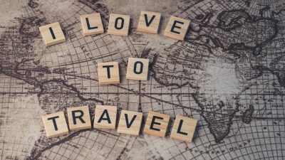 wooden letter tiles on a surface with an image of map
