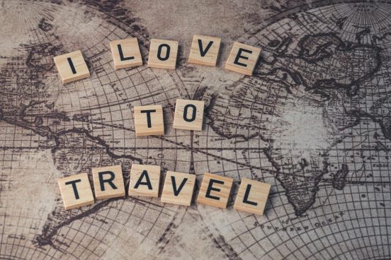 wooden letter tiles on a surface with an image of map