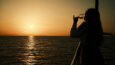 a woman drinking wine in a boat ride