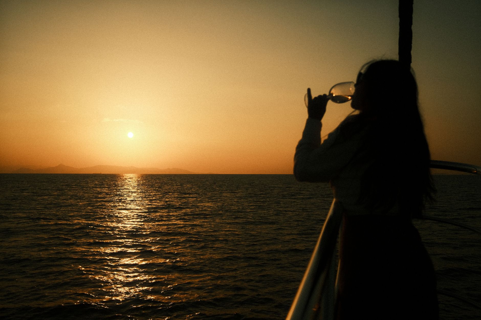 a woman drinking wine in a boat ride