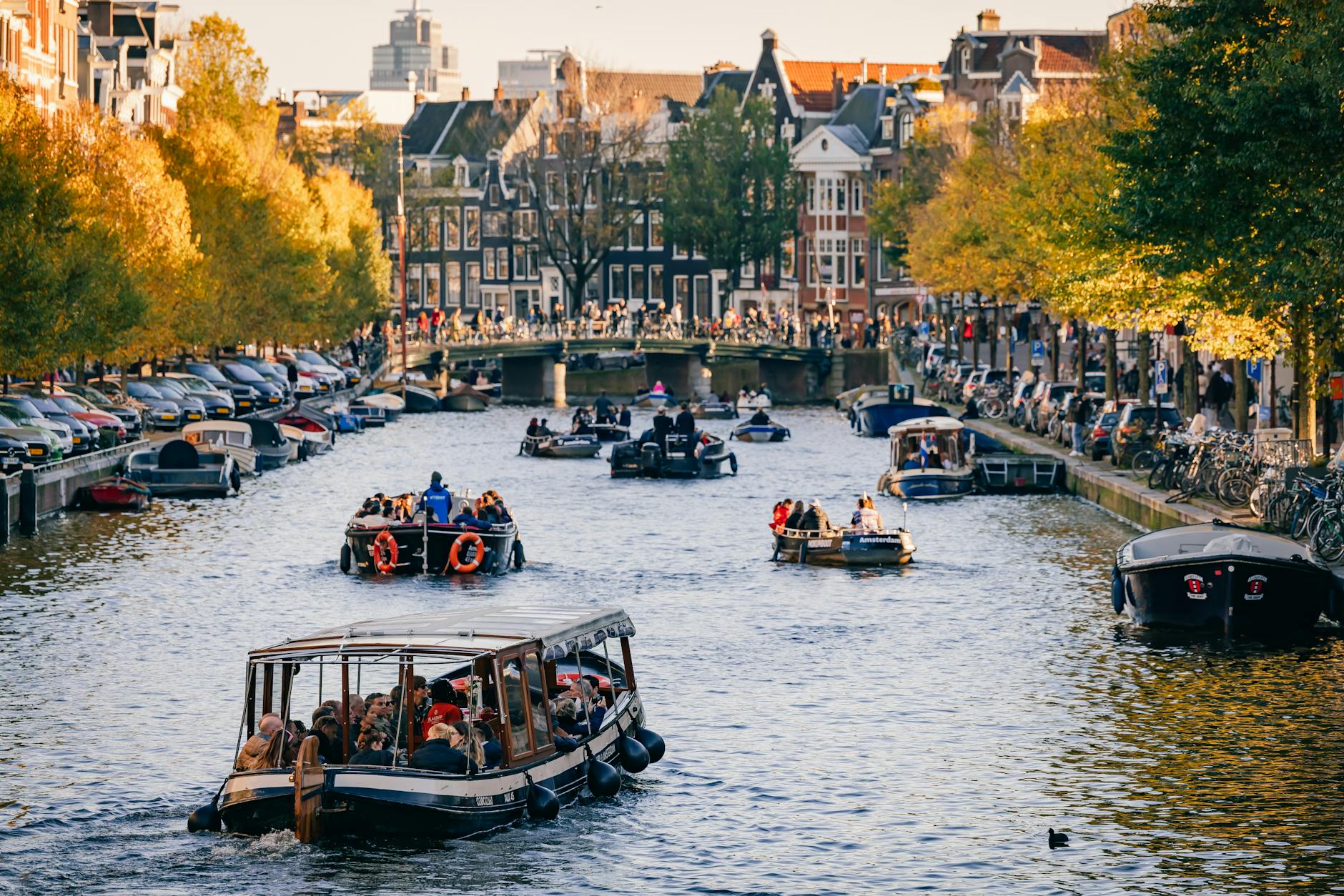 people riding boats on a water canal