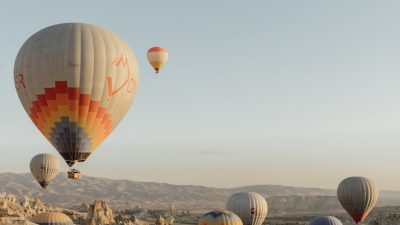 hot air balloons floating over mountains
