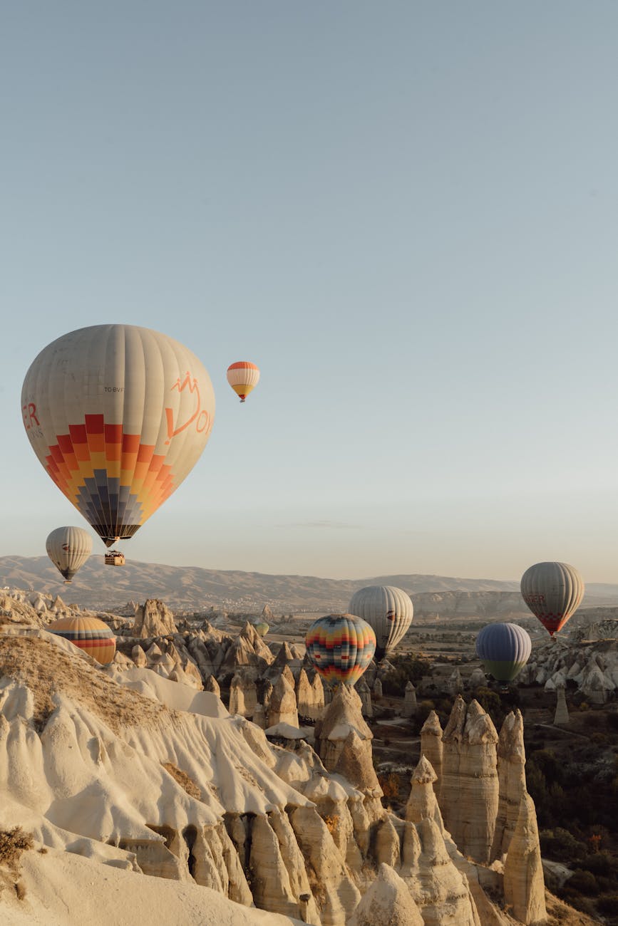 hot air balloons floating over mountains