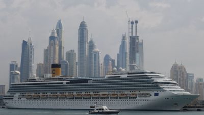 cruise ship in city with skyscrapers