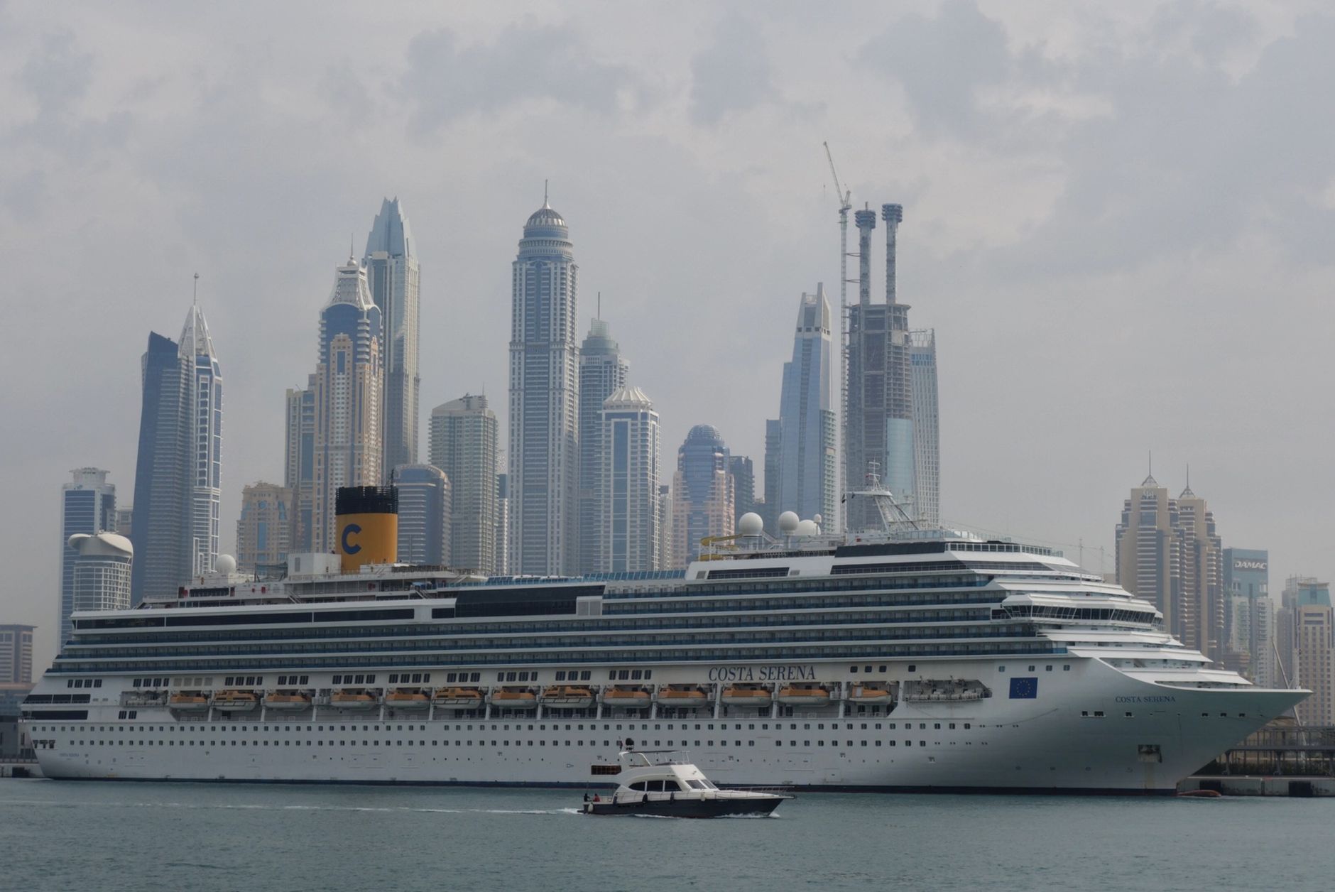 cruise ship in city with skyscrapers