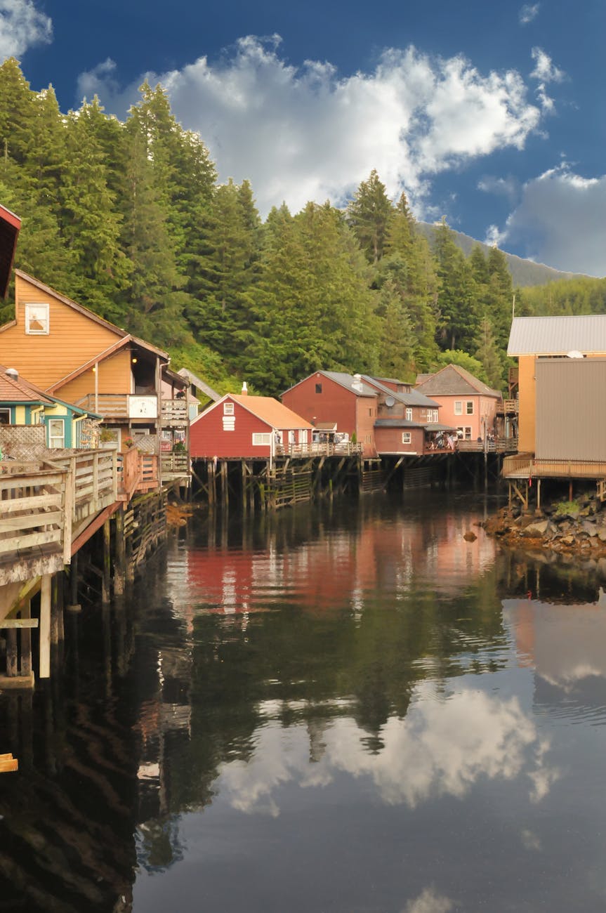houses above body of water under white clouds