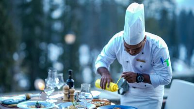 chef finishing meal on restaurant table