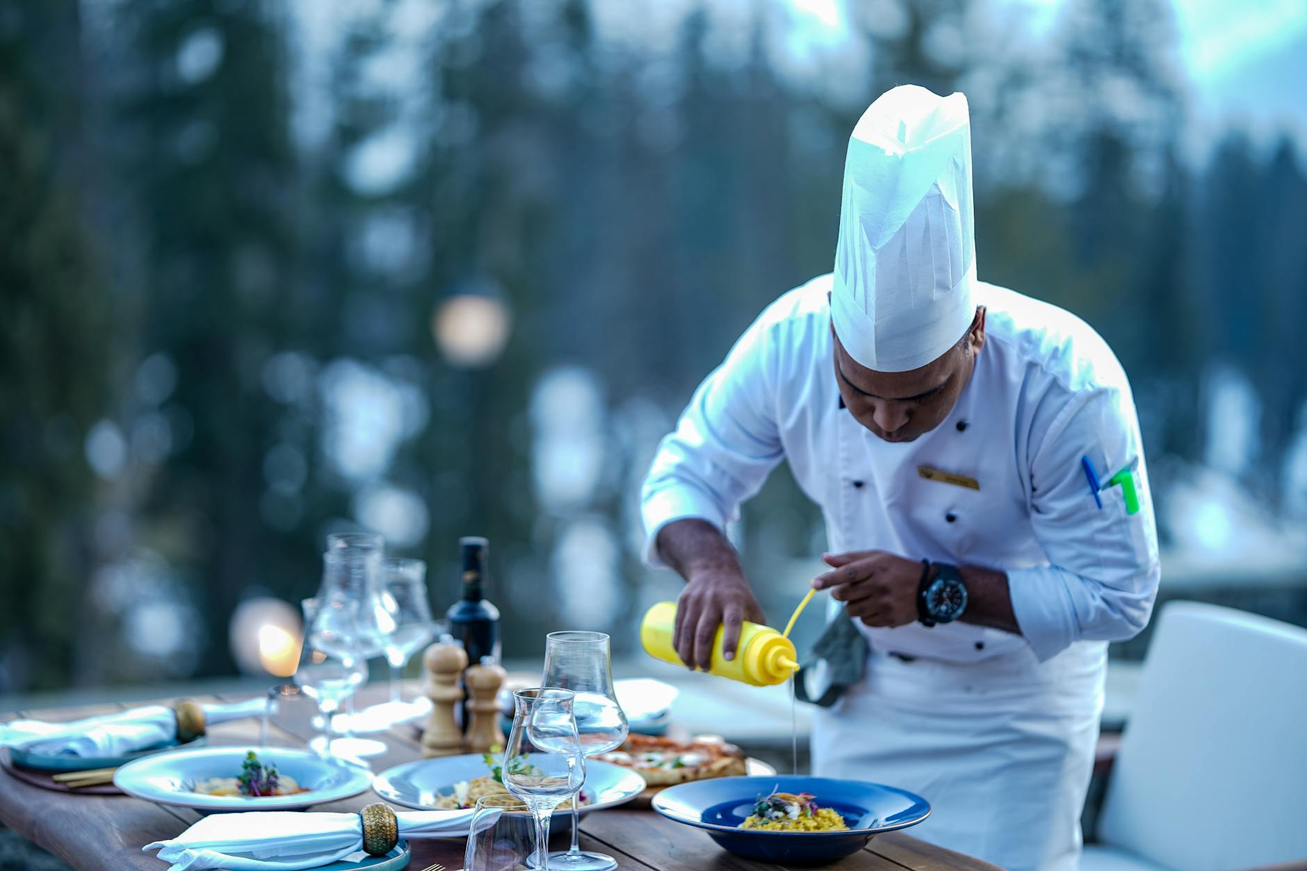 chef finishing meal on restaurant table