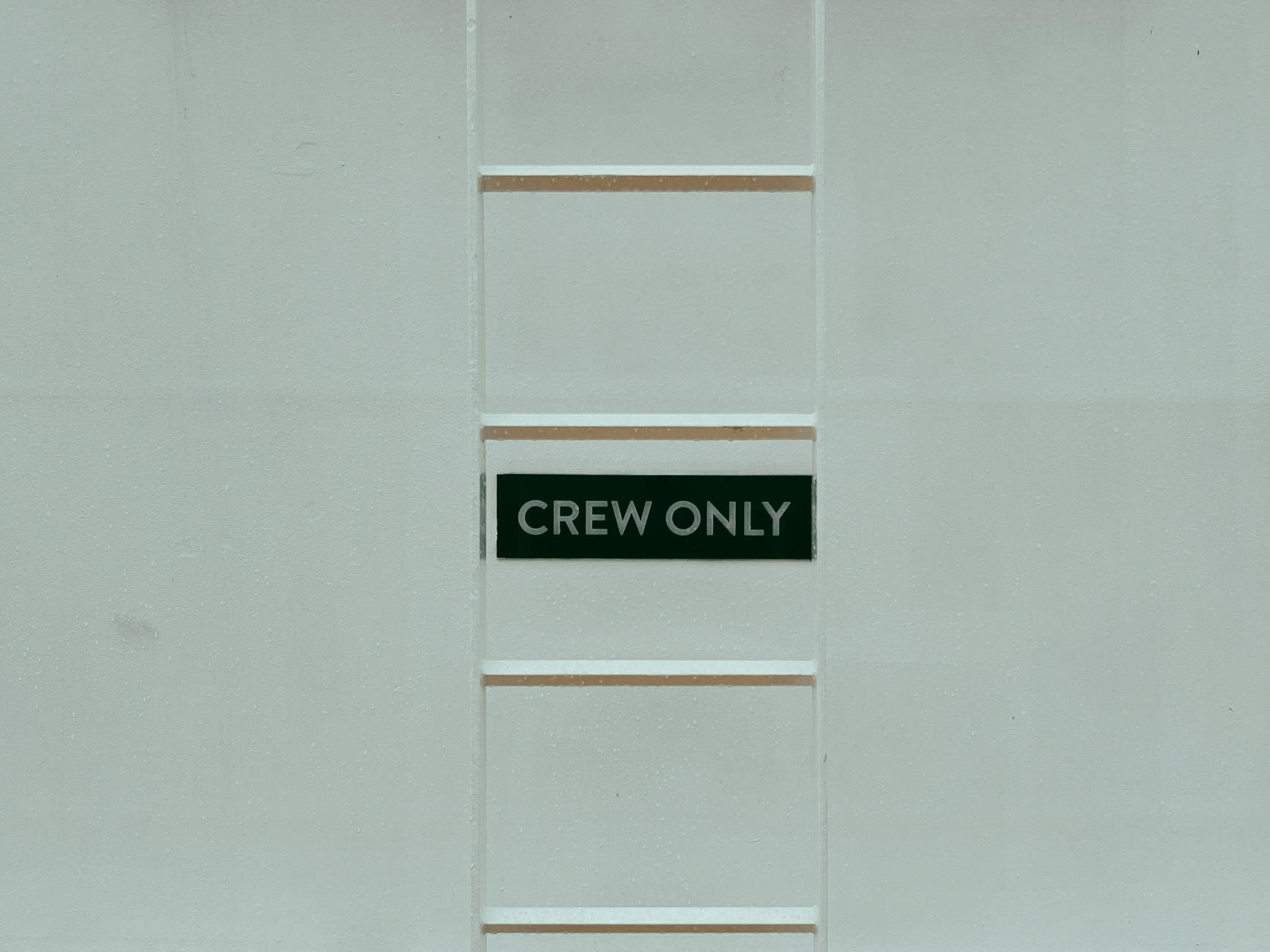 crew only text on board behind ladder