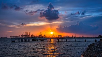 silhouette of a jetty and sea at sunset