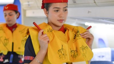 stewardesses demonstrating emergency procedures in a plane