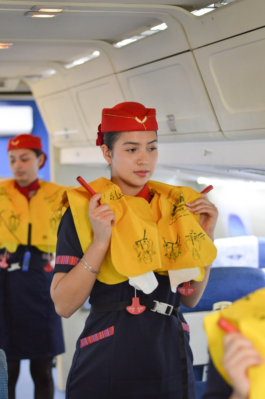 stewardesses demonstrating emergency procedures in a plane
