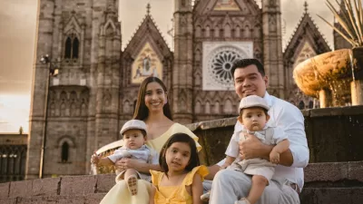 a family with twin baby boys and a daughter posing outdoors
