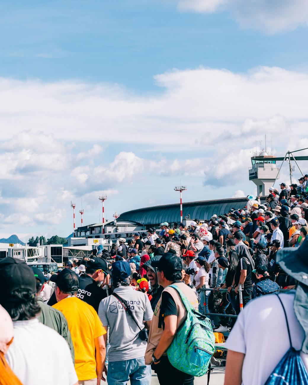 crowd standing on stand on airstrip