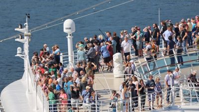 people on passenger ship on sea coast