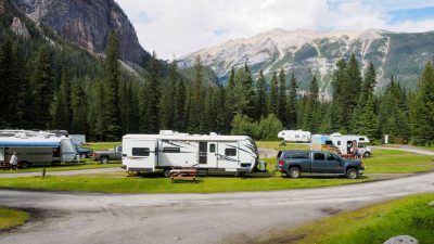 cars with trailers at a campsite in mountains