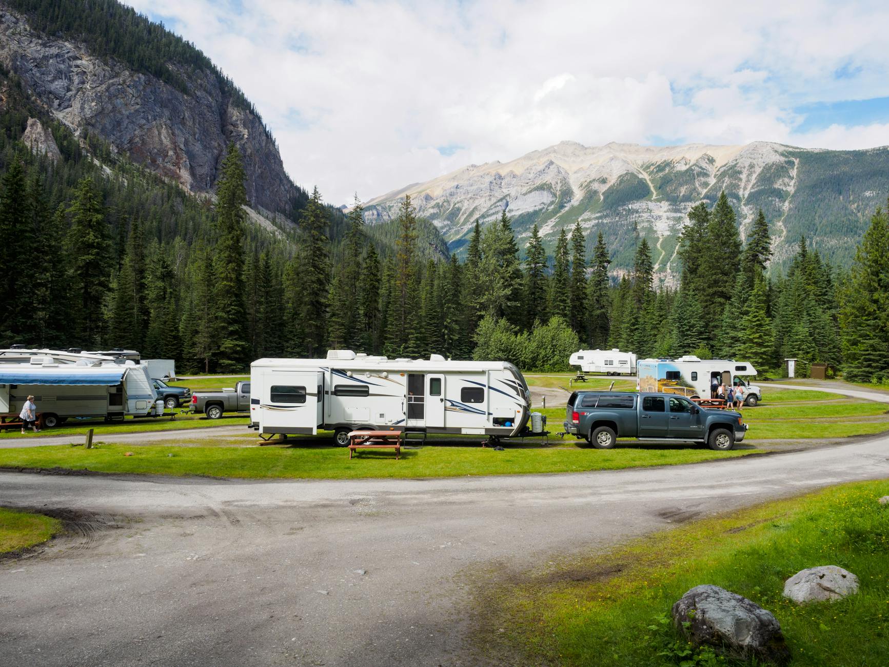 cars with trailers at a campsite in mountains