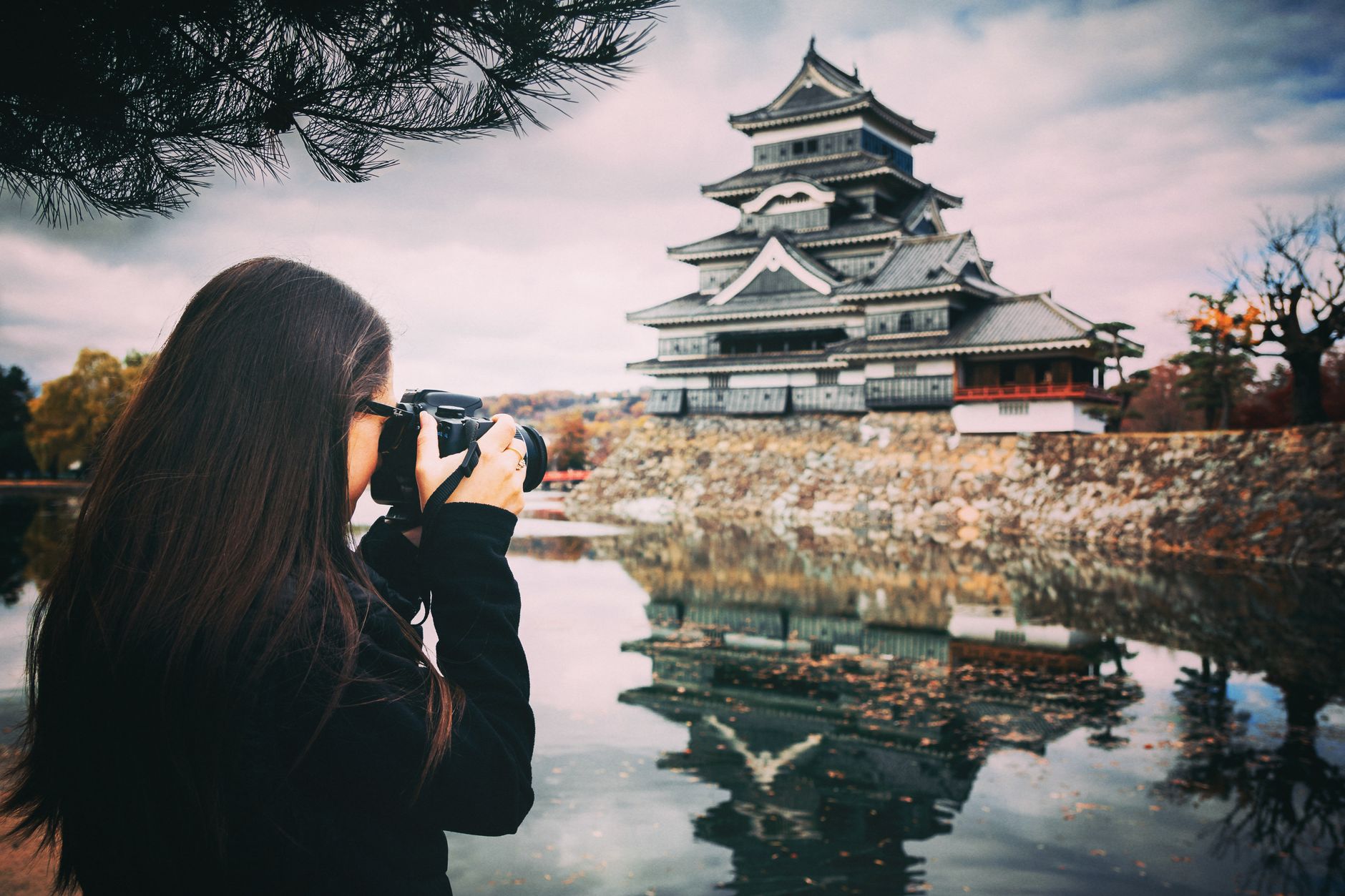 female photographer taking photo of a temple
