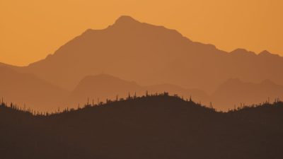silhouettes of mountains at golden hour