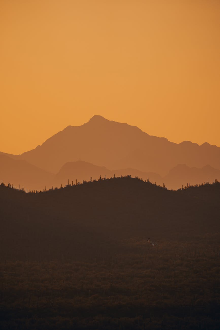 silhouettes of mountains at golden hour