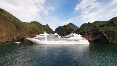 cruise ship in a scenic rocky cove